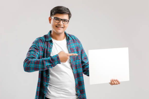 istock Indian/Asian Young Man showing blank signboard on White background 1175161374