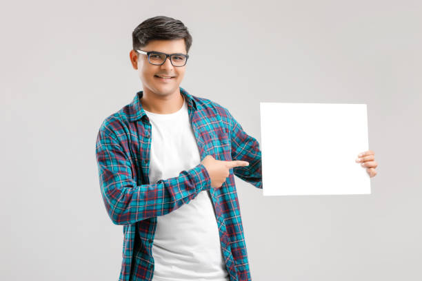 istock Indian/Asian Young Man showing blank signboard on White background 1175161398