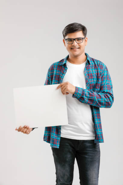istock Indian/Asian Young Man showing blank signboard on White background 1175161405