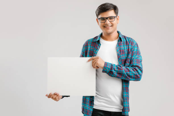 istock Indian/Asian Young Man showing blank signboard on White background 1175161406