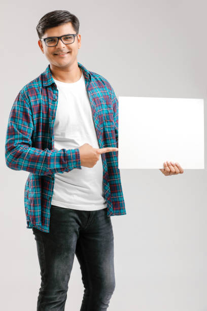 istock Indian/Asian Young Man showing blank signboard on White background 1175161436