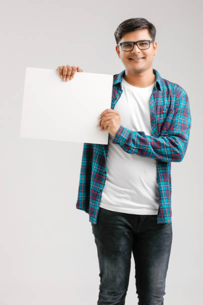 istock Indian/Asian Young Man showing blank signboard on White background 1175161453