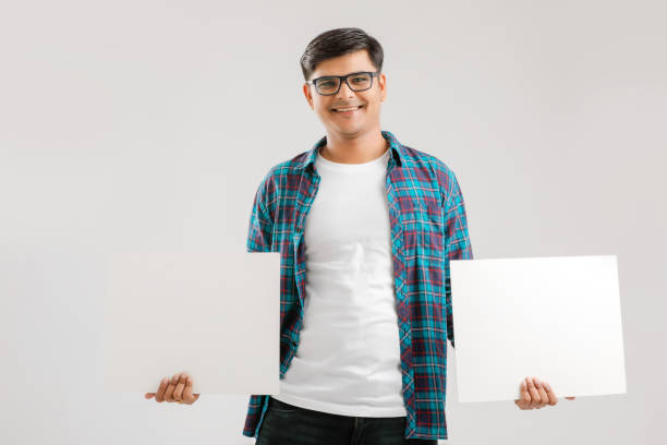 istock Indian/Asian Young Man showing blank signboard on White background 1175161485