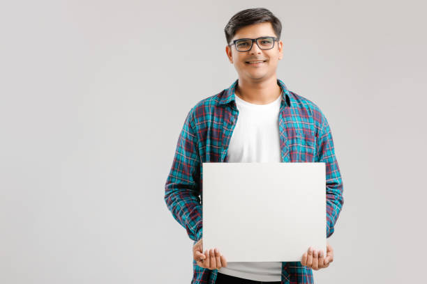 Indian/Asian Young Man showing blank signboard on White background