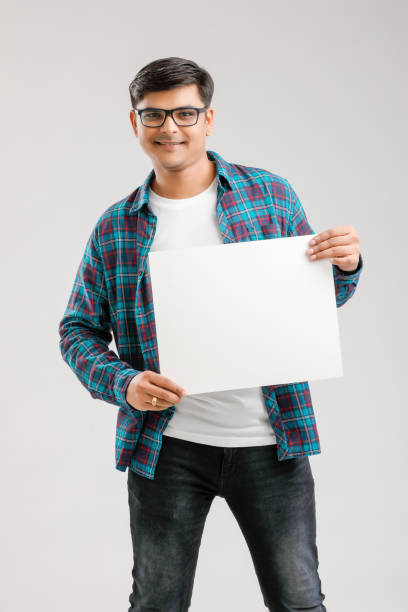istock Indian/Asian Young Man showing blank signboard on White background 1175161499