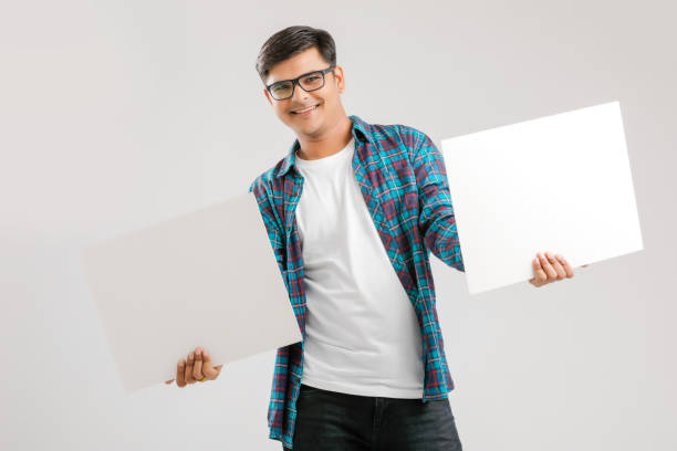 istock Indian/Asian Young Man showing blank signboard on White background 1175161540