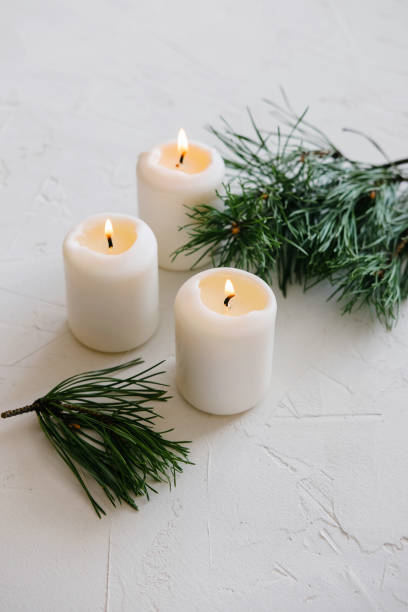 istock White Candles. Christmas mood. Flaming candles on table. 1175164490
