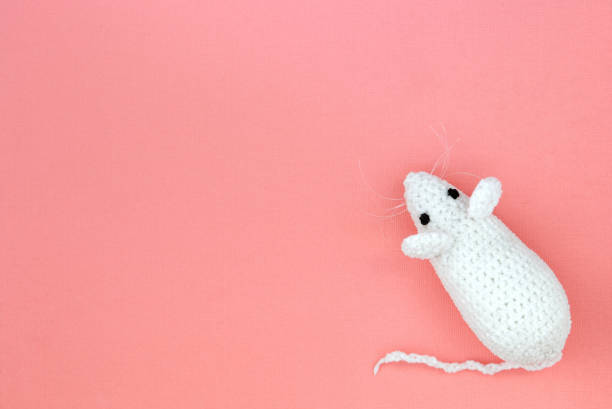 istock White crocheted rat on a pink background. Mouse symbol 2020 new year. Top view, copy space 1175164531