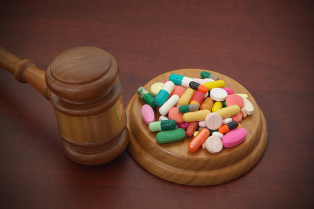 istock Judge gavel with drugs on brown table 1175164614