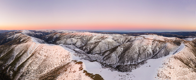 Mt. Hotham Victoria Australia, panorama with pink / orange sky at sunset with snow.