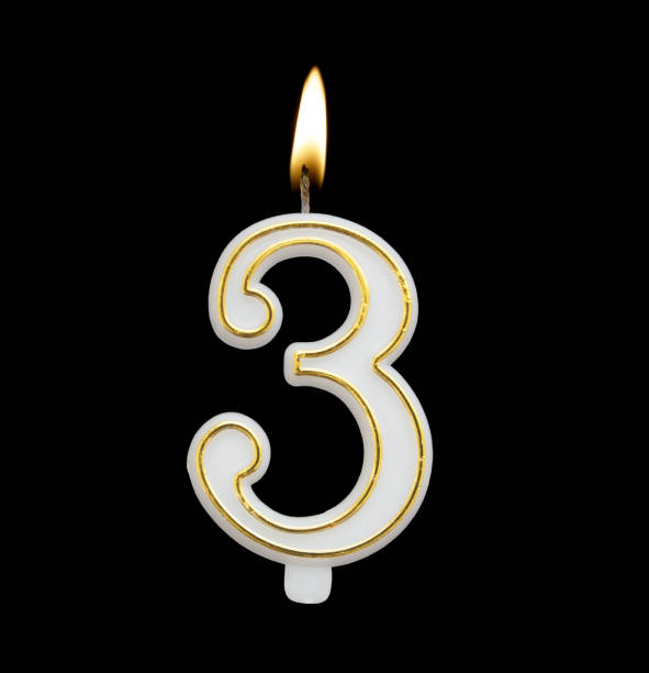 istock Golden birthday candle isolated on black, number 3 1175166347