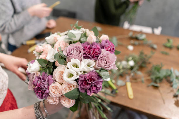 istock education in the school of floristry. Master class on making bouquets. Summer bouquet. Learning flower arranging, making beautiful bouquets with your own hands. Flowers delivery 1175167403