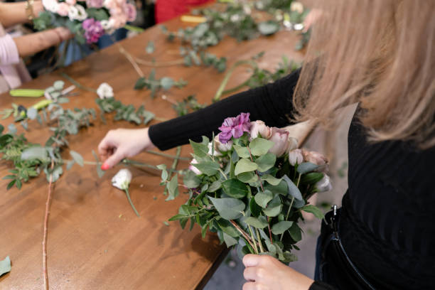 istock education in the school of floristry. Master class on making bouquets. Summer bouquet. Learning flower arranging, making beautiful bouquets with your own hands. Flowers delivery 1175167471