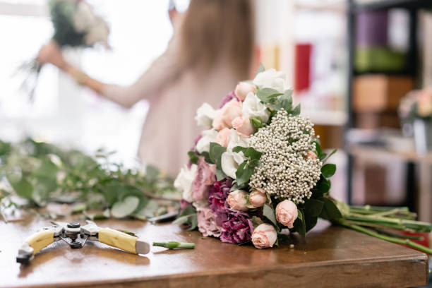 istock education in the school of floristry. Master class on making bouquets. Summer bouquet. Learning flower arranging, making beautiful bouquets with your own hands. Flowers delivery 1175167542