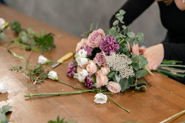 istock education in the school of floristry. Master class on making bouquets. Summer bouquet. Learning flower arranging, making beautiful bouquets with your own hands. Flowers delivery 1175167632