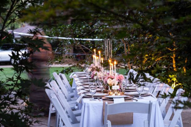 istock Long Outdoor Table Set For A Dinner Party With Custom Flower Arrangements 1175172463