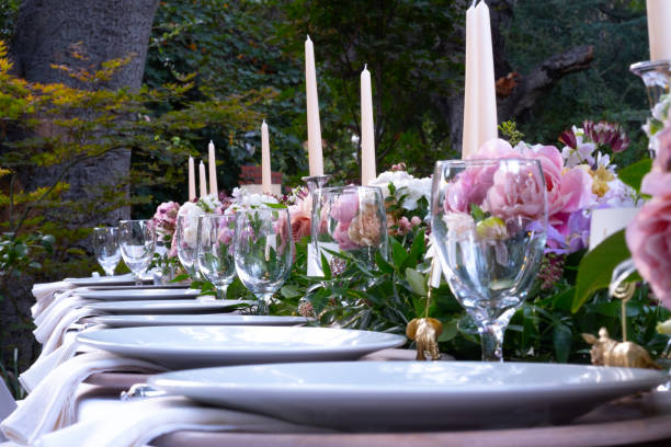 istock Long Outdoor Table Set For A Dinner Party With Custom Flower Arrangements 1175172483