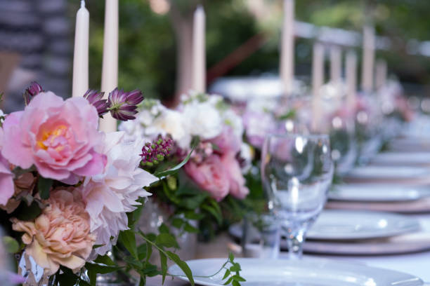 istock Long Outdoor Table Set For A Dinner Party With Custom Flower Arrangements 1175172510