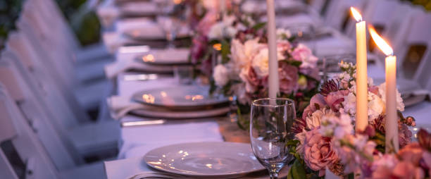 istock Long Outdoor Table Set For A Dinner Party With Custom Flower Arrangements 1175172512