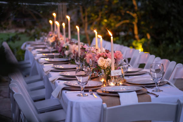 istock Long Outdoor Table Set For A Dinner Party With Custom Flower Arrangements 1175172513