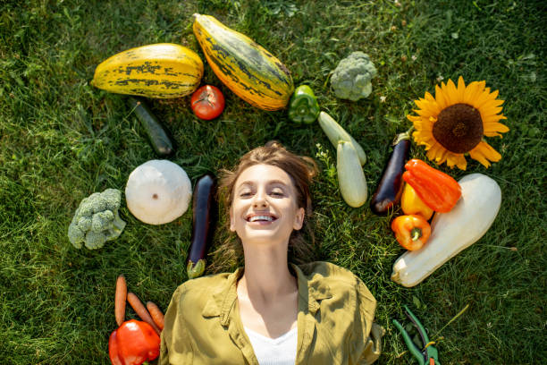 istock Woman with fresh vegetables on the grass 1175172754