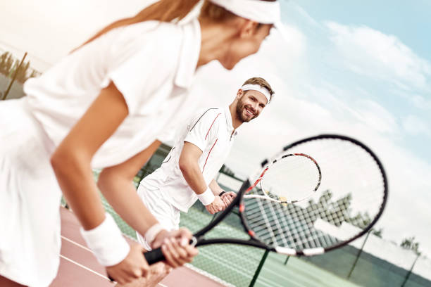 istock Active weekend together. Couple plays tennis 1175172863
