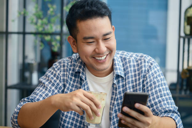 istock Smart Asian man using smartphone in cafe, lifestyle concept. 1175174065