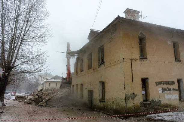 istock Demolition of a house with an orange digger 1175174754