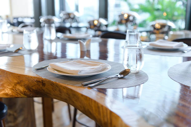 istock Table setting in the restaurant. Decorated elegant table, porcelain plates, glasses, napkin, knife, fork and spoon on wooden table 1175175105