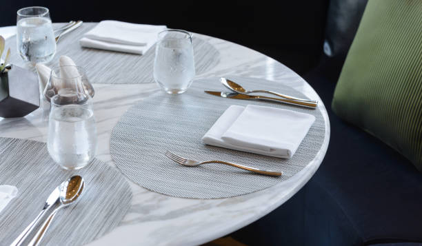 istock Table setting in the restaurant. Decorated elegant table, glasses, napkin, knife, fork and spoon 1175175182