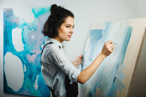 istock Concentrated woman focused on creative art-making process in art therapy 1175175223