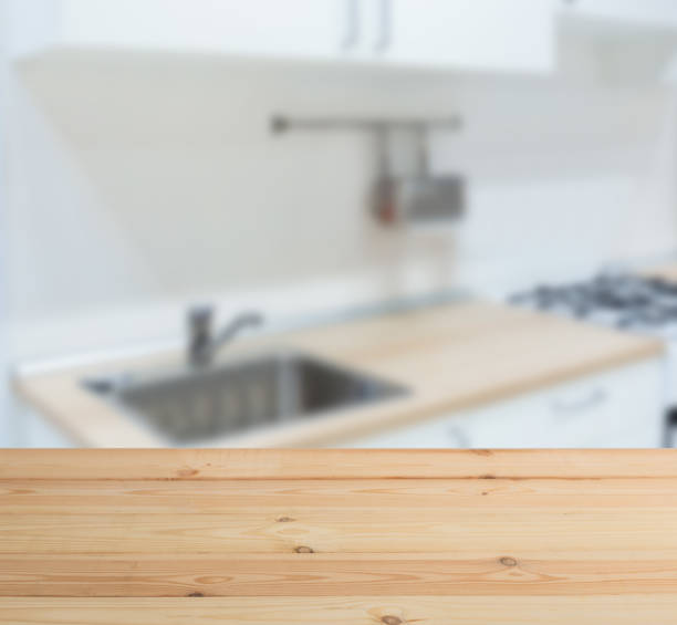 wooden table top and blur kitchen room of the background - domestic kitchen kitchen sink contemporary counter top imagens e fotografias de stock