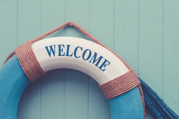 istock Life buoy with welcome text decorate on wooden wall 1175176084