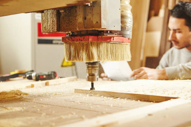 istock Man compares the CNC machine with the drawing. Device with numerical control. 1175176324