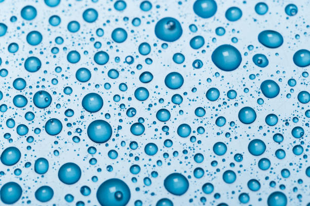 istock Rain droplets on blue glass background, Water drops on blue glass. 1175176473