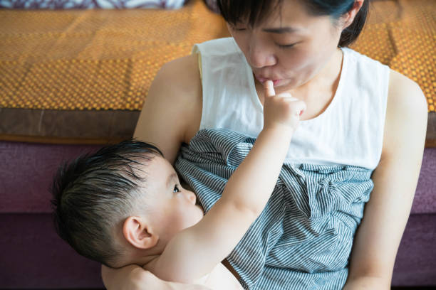 istock Asian mother breastfeeding and hugging her baby. 1175177327
