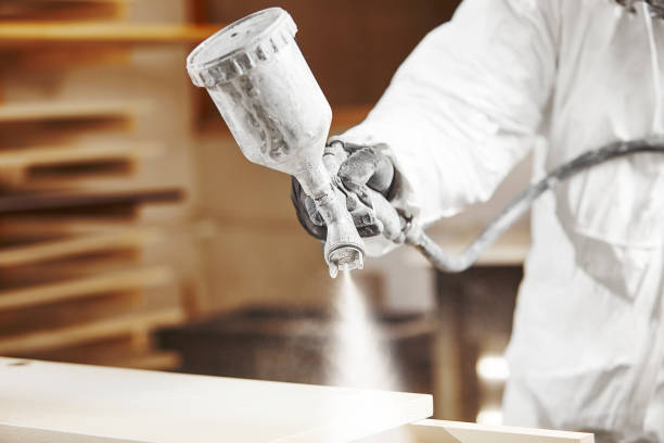 istock Man working with paint spray gun, airless spraying to wood 1175177352