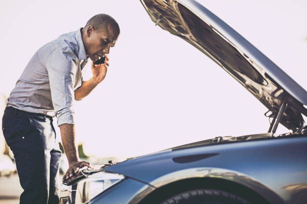 istock African American man calling for help after vehicle breakdown on the street. 1175177625