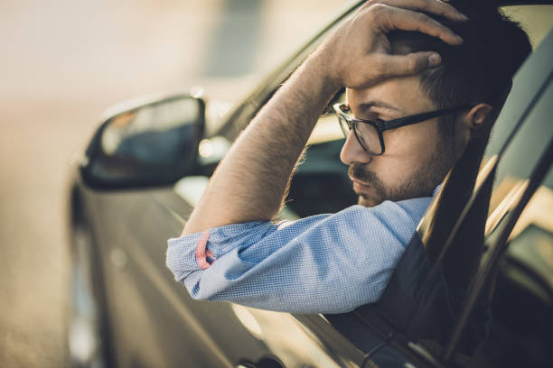 istock Young worried man having problems in a car. 1175177997