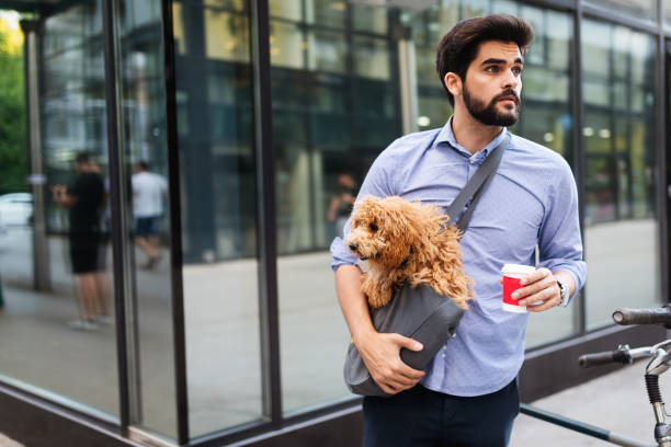 istock Handsome smiling man sitting on a bicycle on the street and drinking coffee. 1175181115