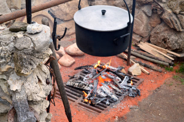istock burning firewood on a grate with a pot 1175181279