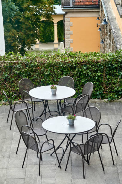 istock Outdoor cafe with white round tables, empty 1175181551