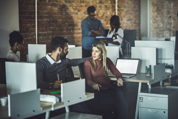 istock Young business colleagues talking at corporate office. 1175183152