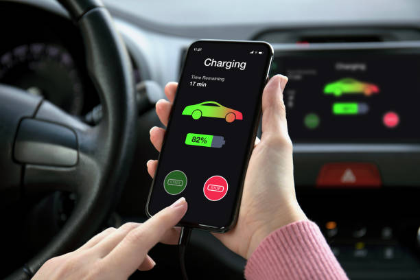 istock phone in eco electric car touch multimedia system charging battery 1175184452