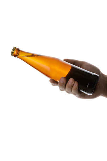 istock male hand holding brown beer bottle 1175184691