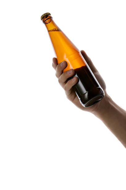 istock male hand holding brown beer bottle 1175184692