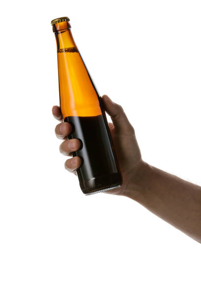 istock male hand holding brown beer bottle 1175184694