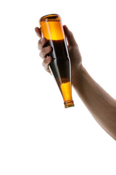 istock male hand holding brown beer bottle 1175184710