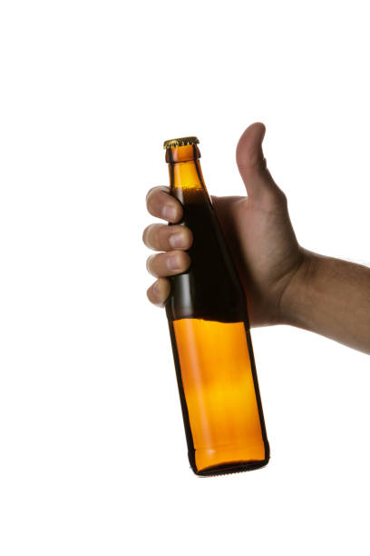 istock male hand holding brown beer bottle 1175184711