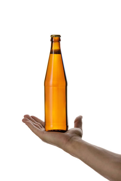 istock male hand holding brown beer bottle 1175184718